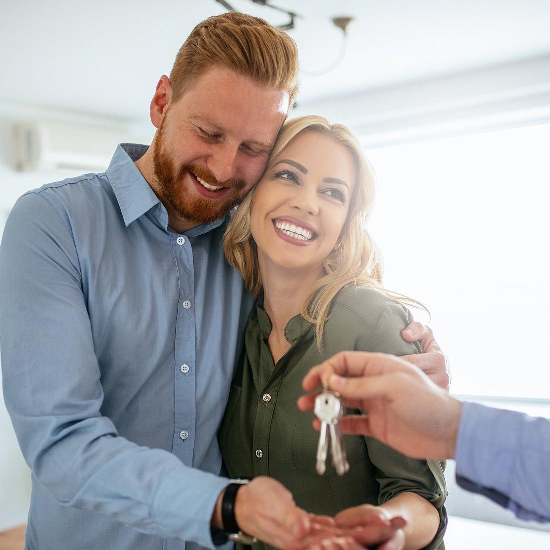 couple getting keys to house